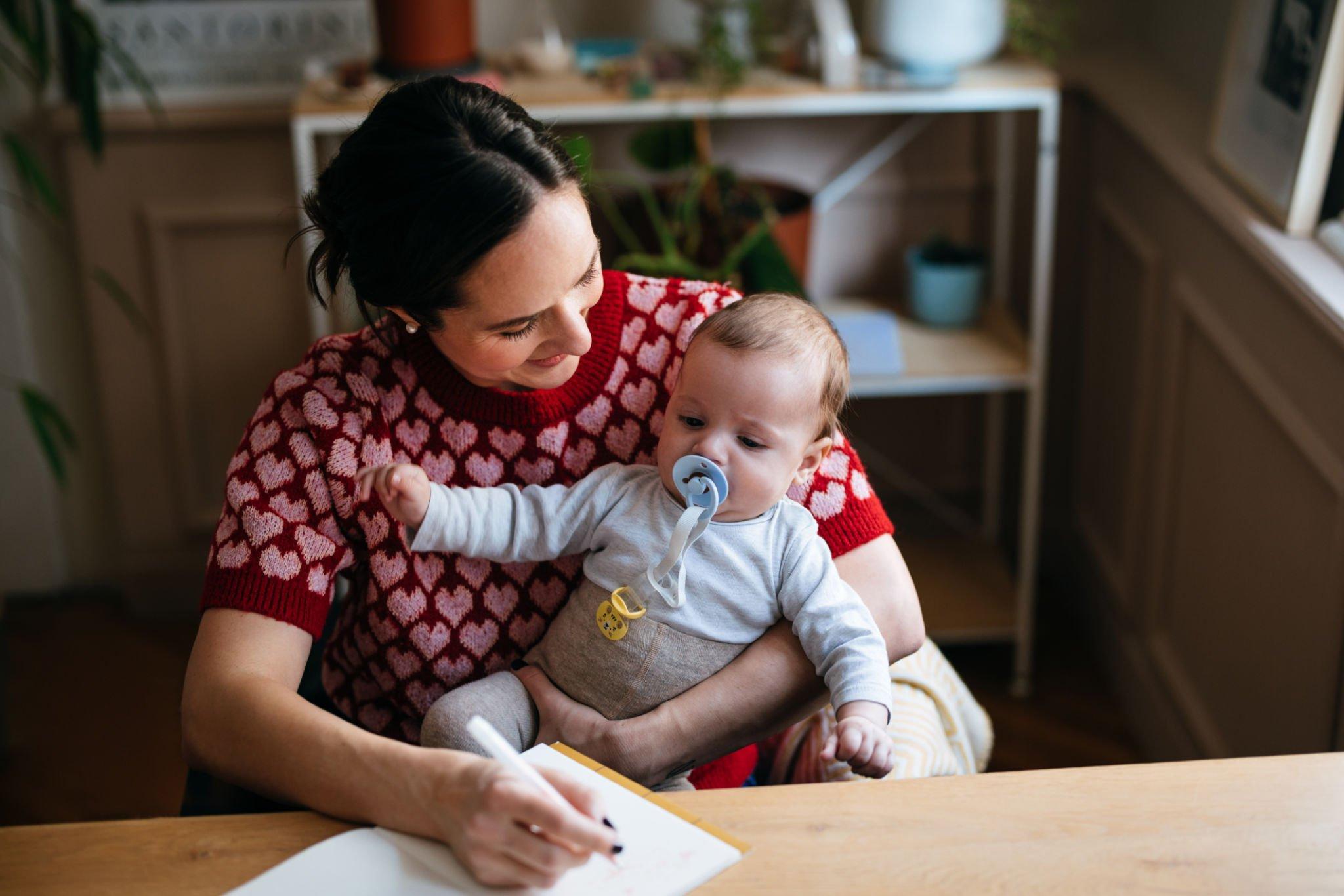 women holding a happy baby with baby essentials