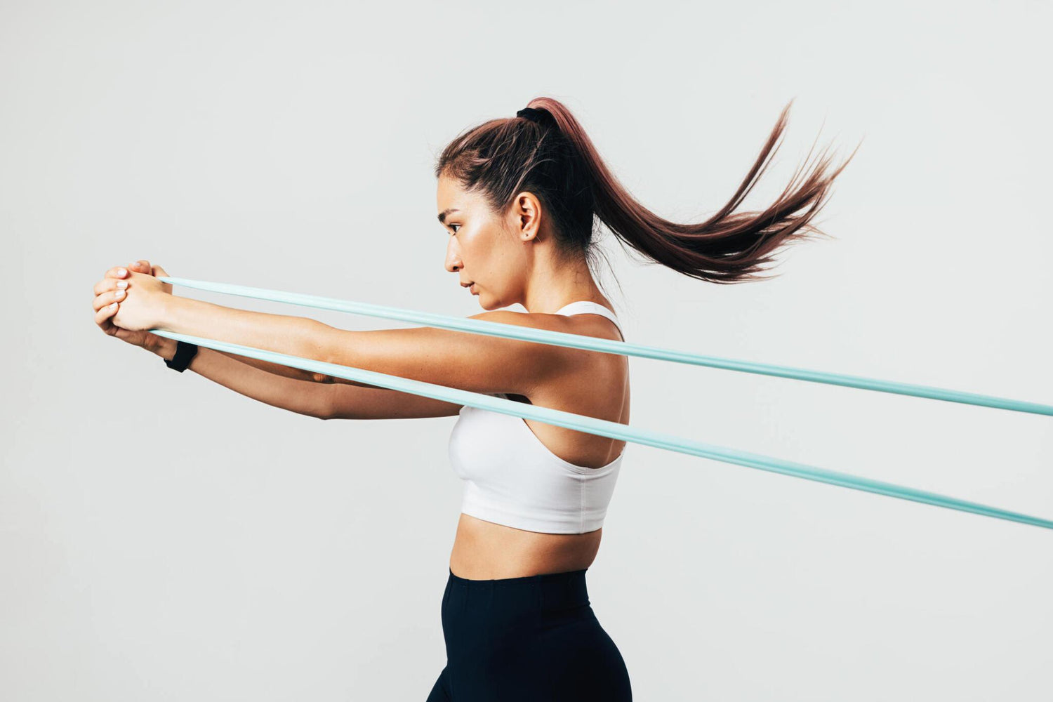 Girl using a stretch band for fitness